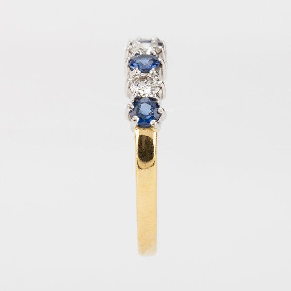 Fine Jewels of Harrogate Modern 0.40 Carat Sapphire and 0.25 Carat Diamond Seven Stone Half Eternity Ring